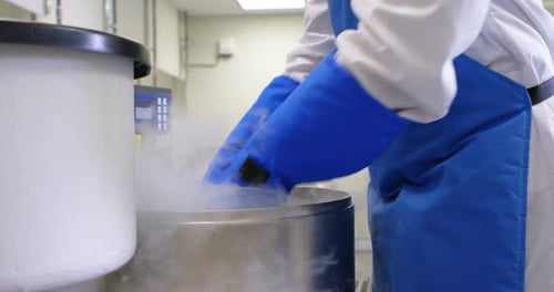 Scientist removing vertical freezer rack from freezer 4k
