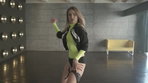 Attractive Girl Is Dancing and Smiling in the Dance Studio. Professional Dancer Is Practicing in the