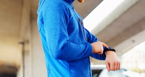 Young man checking his smartwatch on the street, 4K 4k