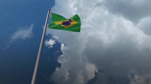 Brazilian Flag Waving in Wind Against Cloudy Sky