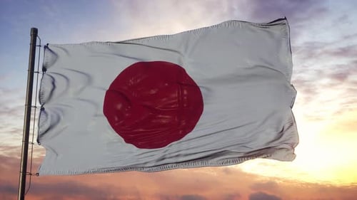 Waving Japan Flag Against Beautiful Sunset Sky