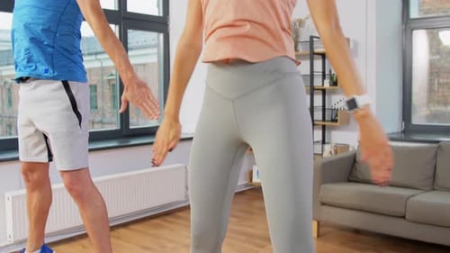 Happy Couple Exercising at Home