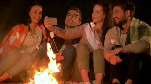 Friends Taking Selfie at Night Camp Fire
