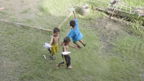 Happy Children Playing With Paper Airplane
