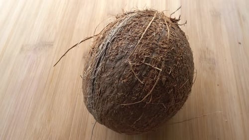Close-Up of a Whole Coconut on Wood