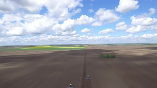 Tractors In A Field Landscape