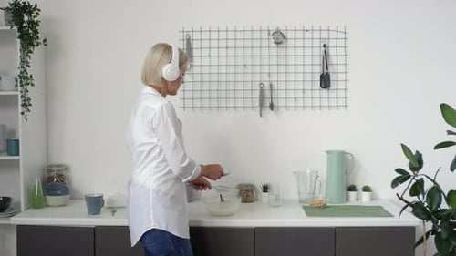 Woman Prepares Food at Kitchen Counter