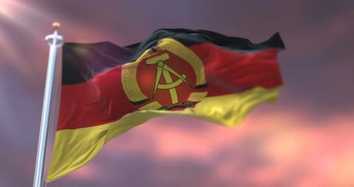 Historic German Democratic Republic Flag Waving Under Sunlight