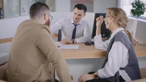 Couple at Modern Reception Desk Talking to Salesperson