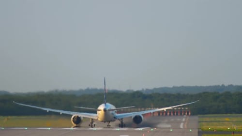 Commercial Airplane Accelerates Down Runway Preparing for Flight