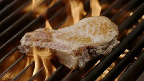Pork Chop Grilling Over Flames