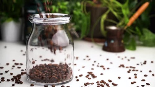 Coffee Beans Poured into a Glass Jar