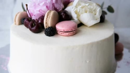 Cake Decorated with Flowers, Macarons, and Cherries