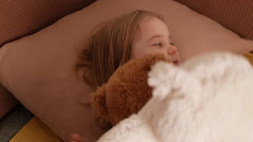 Child Plays with Toys Puts Them to Bed