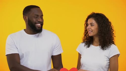 Couple Holding Heart Shape Together