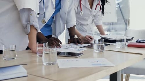 Doctors Reviewing Data at a Table in Office