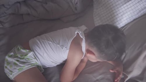 Sleeping Boy Lying in Bed