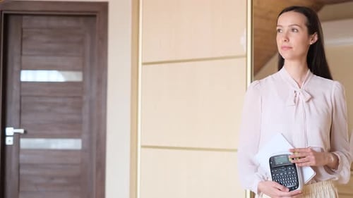 A Woman with the Profession of Space Organizer She Looks Away and Looks at the Camera
