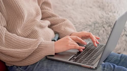 Hands Typing on Laptop Keyboard Indoors