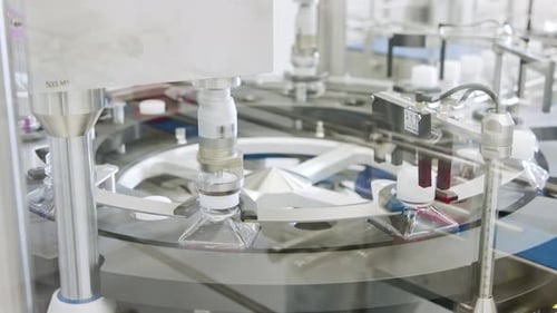 Automated pharmaceutical manufacturing line, bottles filled with liquid