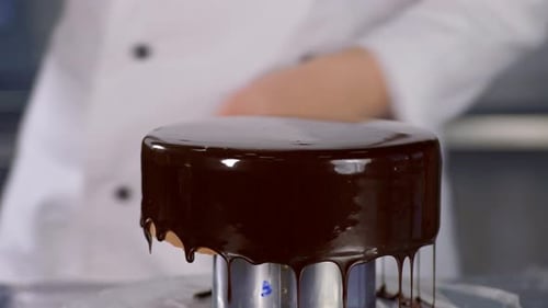 Chocolate Glaze Being Poured Onto Delicious Dessert Cake