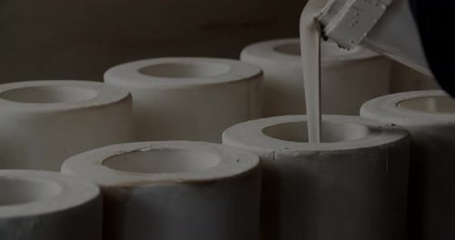 Pouring Clay Into Forms At Pottery Studio