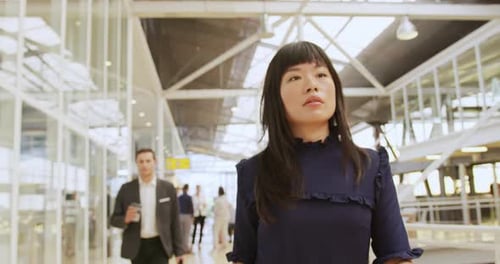 Woman Walks Through Modern Urban Office Space