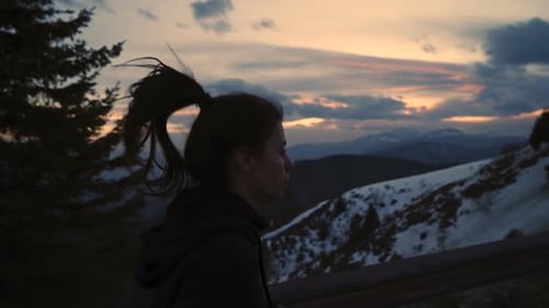 Close View of Running Woman Against Amazing Sunset in the Mountains