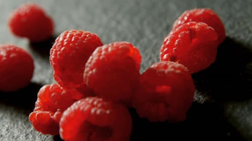 Raspberries on black background 4K 4k