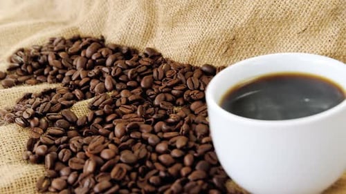 Coffee Beans and Brewed Coffee Cup Close-Up