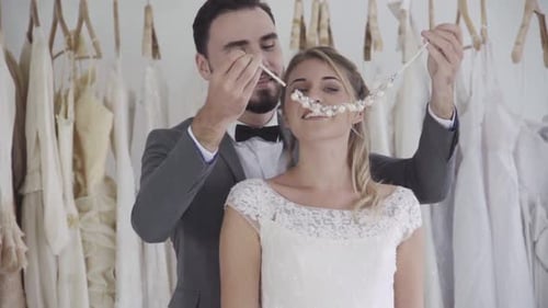 Loving Couple Prepares for Wedding in Bridal Boutique