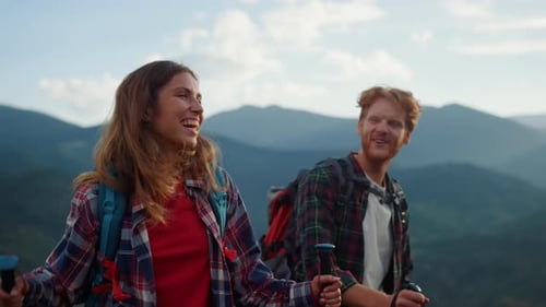Happy Couple Hiking in the Mountains on Sunny Day