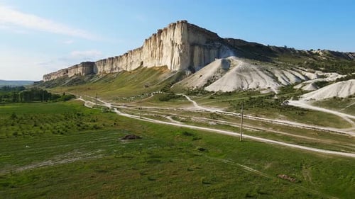 White Vertical Rocky Wall Rising Above the Valley