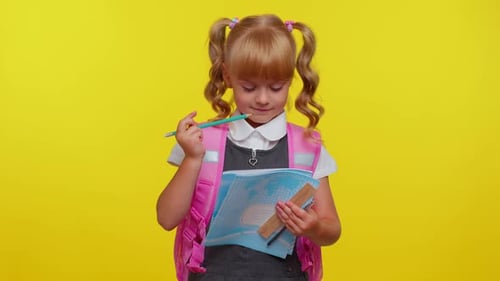 Attractive Teenage Girl Kid in School Uniform Smiling Make Pencil Notes in a Notebook Education