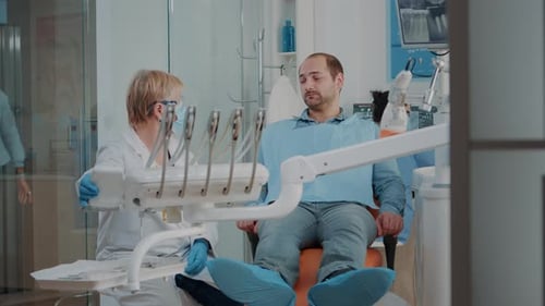 Dentist Consults with Patient in Modern Clinic