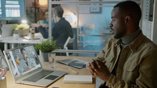 Young Man in Office Attending Video Conference