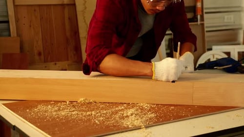 Woodwork and furniture making concept. Stylish craftsman working in his carpentry workshop