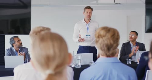Man Giving Corporate Presentation to Audience in Conference