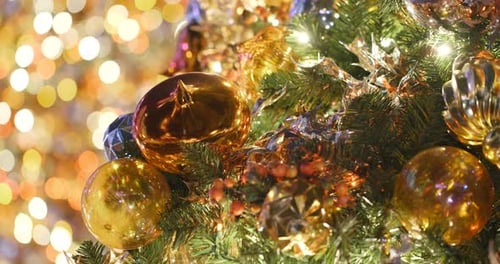 Christmas Tree Closeup with Golden Ornaments and Lights