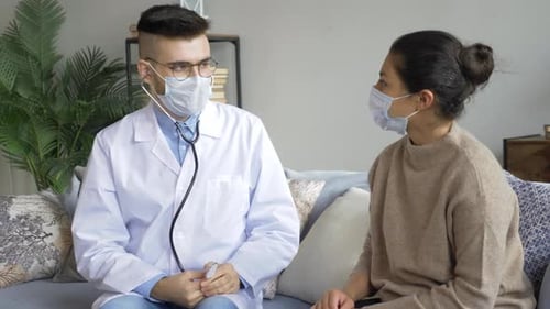 Doctor and Patient Talking on Couch Wearing Face Masks