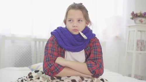 Sick Child Resting with Thermometer in Mouth