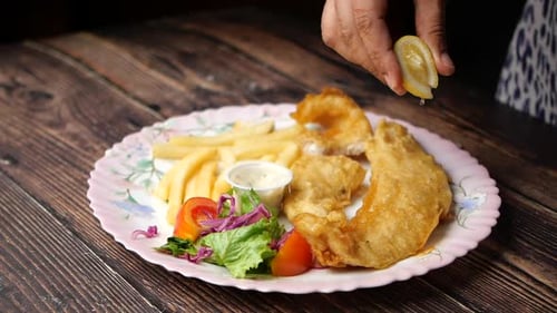 Lemon Squeeze on Delicious Fried Fish and Chips