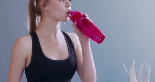 Woman Drinking Water During Fitness Break