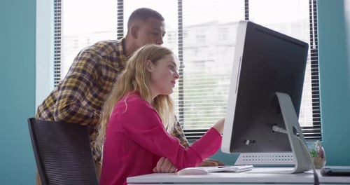 Two Adults Collaborating in a Modern Office