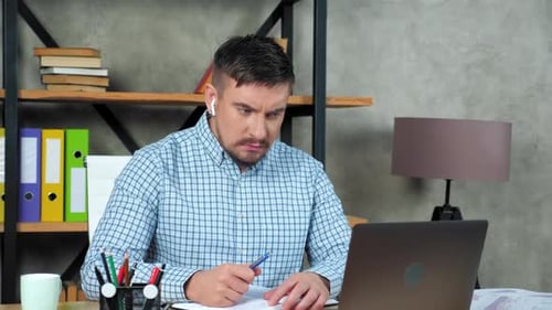 Angry businessman writes report in notebook listen tells company employee online