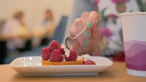 Eating dessert with raspberries