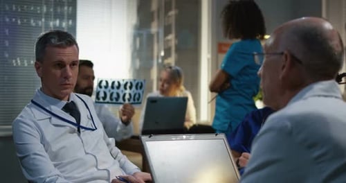 Medical Team Discussing Brain Scan in Hospital Meeting