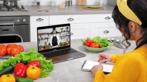 Woman Taking Online Cooking Class in Modern Kitchen