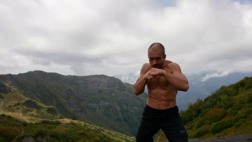 Shirtless Man Boxing in the Mountains