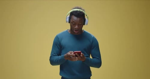 Man Listens to Music and Dances with Headphones